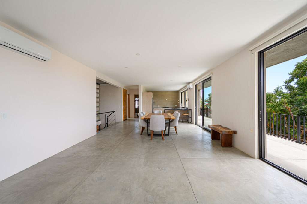 Los Cabos Gringo Hill Tucked into the coveted hillside community of Gringo Hills in Costa Azul, Casa Asha is a contemporary residence by architect Gonzalo Elizarraras. Set on a 519SM lot, the three-bedroom home blends natural Baja materials with modern architecture, open living spaces, and expansive terraces. The upper-level living, dining, and kitchen flow to a generous terrace, while the lower level opens to a lush garden ideal for entertaining under the shade of mature trees. The rooftop offers a versatile space perfect for sunrise yoga, morning coffee, or a barbecue overlooking the Sea of Cortez. A brief 900-meters to the shores of Costa Azul and minutes from San José's historic center, Gringo Hills offers a relaxed lifestyle loved by surfers, artists, and long-time locals. – 122 Punta Conejo, San Jose del Cabo, BS