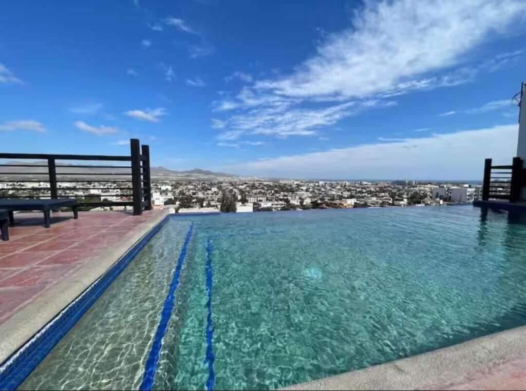 Los Cabos Morgan Residences Your perfect condo in Cabo! Excellent Airbnb rental or your very own centrally located to downtown and the Marina home. Fully furnished 2 bedroom, 2 bath spacious unit with a lock off option! Making it perfect to live and enjoy rental income, or have two rentals at once, with complete privacy. Exclusive entrance, gated community, covered parking, equipped gym, sunny rooftop terrace with pool, amazing – 1921 C. 8 De Octubre, Cabo San Lucas, BS