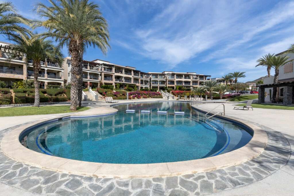 Los Cabos Cora One of the lowest-priced furnished residences currently available in Cora, this 2024-built condo is move-in ready and located within Club Campestre in San José del Cabo. The floor plan offers 3 bedrooms and 3.5 baths with approximately 1,841 sq ft of interior living space. Bright, modern interiors feature large-format tile flooring, an open-concept kitchen with island seating, and expansive sliding glass doors that connect seamlessly to oversized private decks. The interior design emphasizes clean lines, neutral finishes, and a cohesive open layout that connects the kitchen, dining, and living areas into a single, light-filled space. The kitchen is centered around a large island with quartz-style surfaces, modern cabinetry, and pendant lighting, opening directly to the main living area for easy entertaining. Floor-to-ceiling sliding glass doors extend the living space outdoors, creating a strong indoor-outdoor connection and allowing natural light to flow throughout the residence.Living and dining areas are furnished with contemporary pieces scaled appropriately for the space, complementing the modern architectural style seen throughout the development. Bedrooms are well-proportioned and designed for privacy, while bathrooms feature glass-enclosed showers and streamlined finishes consistent with the home's overall aesthetic. Privacy blinds, LED televisions with integrated switching, and thoughtfully placed lighting add functionality while maintaining a clean visual profile.Outdoor living areas are a standout feature, with expansive decks and patios offering generous space for seating, dining, and relaxation while overlooking the community's architectural landscaping and surrounding natural terrain.. Two covered on-property parking spaces include electricity and water connections suitable for electric vehicle charging or vehicle washing, and a private 10x10x14 storage locker with electricity provides secure owner storage.Cora is a gated, master-planned community within Campestre San José, featuring contemporary architecture and resort-style amenities visible throughout the property. Community offerings include a large swimming pool with integrated lounging areas, a hot tub, fitness center, indoor children's play area, and an enclosed dog park, all supported by 24/7 security. The Campestre San José golf course is approximately 0.5 miles away, and the private beach club on the Sea of Cortez is roughly 2.5 miles from the residence, subject to membership terms.Dining, recreation, and services are easily accessible, with Flora Farms approximately 2.8 miles away, Acre Restaurant about 3.0 miles, and the Historic Art District of downtown San José del Cabo roughly 4.5 miles from the property. Beachfront dining along the Tourist Corridor, including venues such as Veleros Beach Club and 7 Seas Grille & Seafood, is approximately 6.5 miles away, while Los Cabos International Airport is about 10.5 miles from the residence.Offered fully furnished and... – (2) Car Garage Included, Cabo Corridor, BS