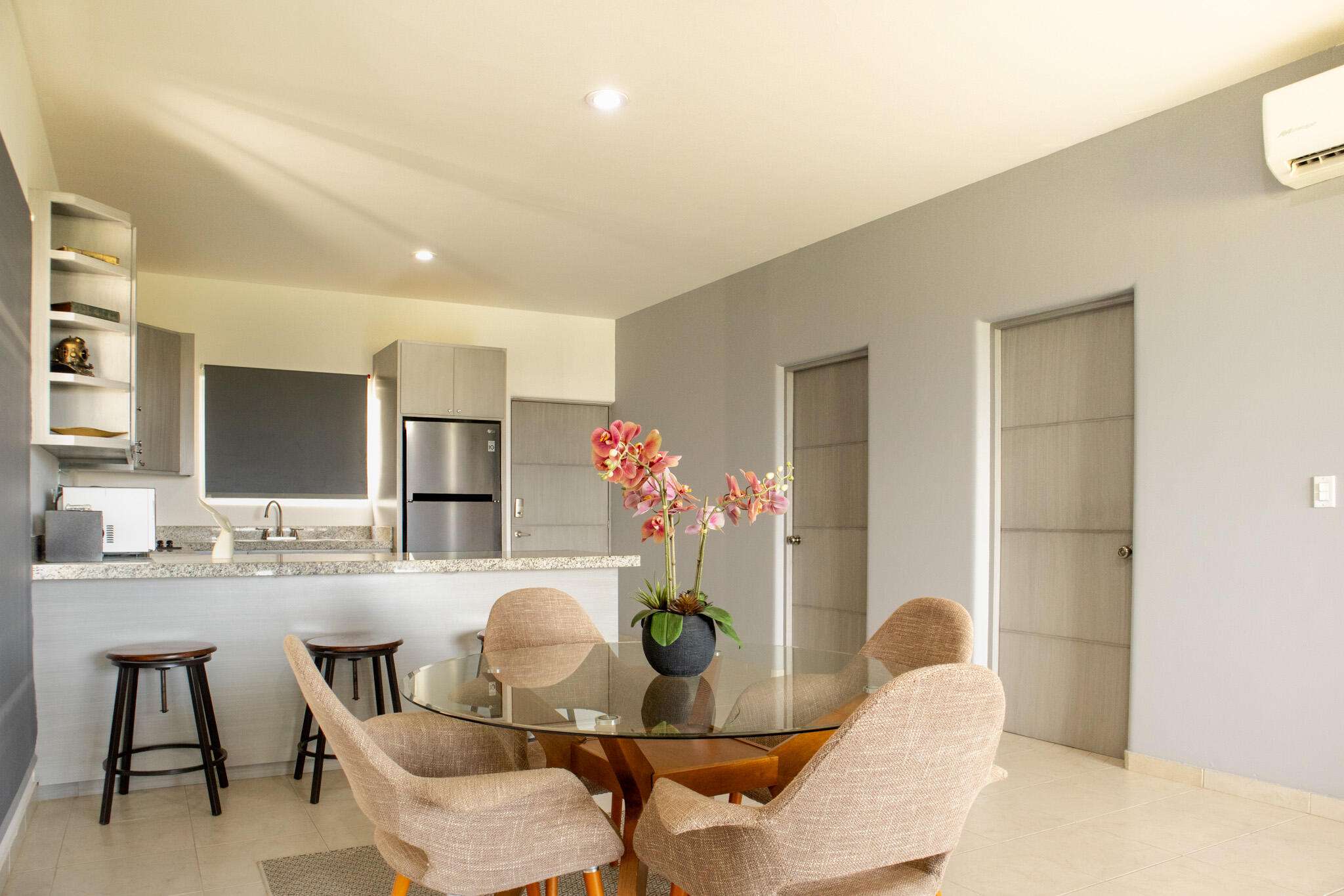 Los Cabos Cora One of the lowest-priced furnished residences currently available in Cora, this 2024-built condo is move-in ready and located within Club Campestre in San José del Cabo. The floor plan offers 3 bedrooms and 3.5 baths with approximately 1,841 sq ft of interior living space. Bright, modern interiors feature large-format tile flooring, an open-concept kitchen with island seating, and expansive sliding glass doors that connect seamlessly to oversized private decks. The interior design emphasizes clean lines, neutral finishes, and a cohesive open layout that connects the kitchen, dining, and living areas into a single, light-filled space. The kitchen is centered around a large island with quartz-style surfaces, modern cabinetry, and pendant lighting, opening directly to the main living area for easy entertaining. Floor-to-ceiling sliding glass doors extend the living space outdoors, creating a strong indoor-outdoor connection and allowing natural light to flow throughout the residence.Living and dining areas are furnished with contemporary pieces scaled appropriately for the space, complementing the modern architectural style seen throughout the development. Bedrooms are well-proportioned and designed for privacy, while bathrooms feature glass-enclosed showers and streamlined finishes consistent with the home's overall aesthetic. Privacy blinds, LED televisions with integrated switching, and thoughtfully placed lighting add functionality while maintaining a clean visual profile.Outdoor living areas are a standout feature, with expansive decks and patios offering generous space for seating, dining, and relaxation while overlooking the community's architectural landscaping and surrounding natural terrain.. Two covered on-property parking spaces include electricity and water connections suitable for electric vehicle charging or vehicle washing, and a private 10x10x14 storage locker with electricity provides secure owner storage.Cora is a gated, master-planned community within Campestre San José, featuring contemporary architecture and resort-style amenities visible throughout the property. Community offerings include a large swimming pool with integrated lounging areas, a hot tub, fitness center, indoor children's play area, and an enclosed dog park, all supported by 24/7 security. The Campestre San José golf course is approximately 0.5 miles away, and the private beach club on the Sea of Cortez is roughly 2.5 miles from the residence, subject to membership terms.Dining, recreation, and services are easily accessible, with Flora Farms approximately 2.8 miles away, Acre Restaurant about 3.0 miles, and the Historic Art District of downtown San José del Cabo roughly 4.5 miles from the property. Beachfront dining along the Tourist Corridor, including venues such as Veleros Beach Club and 7 Seas Grille & Seafood, is approximately 6.5 miles away, while Los Cabos International Airport is about 10.5 miles from the residence.Offered fully furnished and... for sale