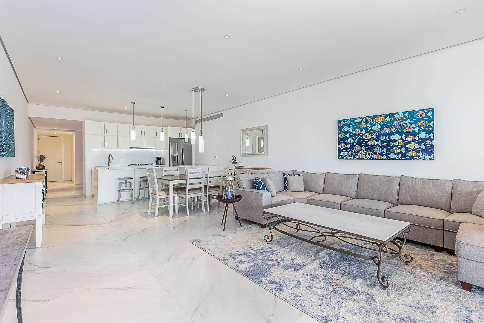 Los Cabos Cora One of the lowest-priced furnished residences currently available in Cora, this 2024-built condo is move-in ready and located within Club Campestre in San José del Cabo. The floor plan offers 3 bedrooms and 3.5 baths with approximately 1,841 sq ft of interior living space. Bright, modern interiors feature large-format tile flooring, an open-concept kitchen with island seating, and expansive sliding glass doors that connect seamlessly to oversized private decks. The interior design emphasizes clean lines, neutral finishes, and a cohesive open layout that connects the kitchen, dining, and living areas into a single, light-filled space. The kitchen is centered around a large island with quartz-style surfaces, modern cabinetry, and pendant lighting, opening directly to the main living area for easy entertaining. Floor-to-ceiling sliding glass doors extend the living space outdoors, creating a strong indoor-outdoor connection and allowing natural light to flow throughout the residence.Living and dining areas are furnished with contemporary pieces scaled appropriately for the space, complementing the modern architectural style seen throughout the development. Bedrooms are well-proportioned and designed for privacy, while bathrooms feature glass-enclosed showers and streamlined finishes consistent with the home's overall aesthetic. Privacy blinds, LED televisions with integrated switching, and thoughtfully placed lighting add functionality while maintaining a clean visual profile.Outdoor living areas are a standout feature, with expansive decks and patios offering generous space for seating, dining, and relaxation while overlooking the community's architectural landscaping and surrounding natural terrain.. Two covered on-property parking spaces include electricity and water connections suitable for electric vehicle charging or vehicle washing, and a private 10x10x14 storage locker with electricity provides secure owner storage.Cora is a gated, master-planned community within Campestre San José, featuring contemporary architecture and resort-style amenities visible throughout the property. Community offerings include a large swimming pool with integrated lounging areas, a hot tub, fitness center, indoor children's play area, and an enclosed dog park, all supported by 24/7 security. The Campestre San José golf course is approximately 0.5 miles away, and the private beach club on the Sea of Cortez is roughly 2.5 miles from the residence, subject to membership terms.Dining, recreation, and services are easily accessible, with Flora Farms approximately 2.8 miles away, Acre Restaurant about 3.0 miles, and the Historic Art District of downtown San José del Cabo roughly 4.5 miles from the property. Beachfront dining along the Tourist Corridor, including venues such as Veleros Beach Club and 7 Seas Grille & Seafood, is approximately 6.5 miles away, while Los Cabos International Airport is about 10.5 miles from the residence.Offered fully furnished and... for sale