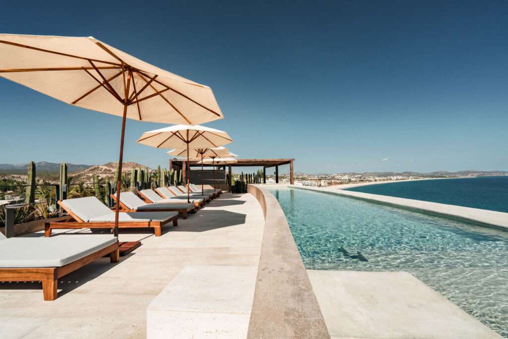 Los Cabos Dunna Welcome to Dunna - A New Standard of Luxury in Cabo. More than a residence, Dunna is a vibrant, fully integrated community where luxury, culture, and recreation converge. Designed by renowned architect Sordo Madaleno, this visionary development seamlessly blends timeless elegance with natural tranquility, offering meticulously crafted residences and garden villas complemented by world-class amenities. Elevated Living, Unmatched Experiences Choose from 13 thoughtfully designed floor plans from 2 - 5 bedrooms ranging from 1,475 - 6,458 sq. ft., featuring seamless indoor-outdoor living, elegant finishes, private rooftops, Jacuzzis, and lush garden terraces. Resort-Style AmenitiesEnjoy unparalleled amenities, including:" Infinity pools (Adults-only, Family, Kids & Oasis)" State-of-the-art wellness & fitness center" Luxury spa (sauna, steam, ice baths, massage suites)" Exclusive rooftop lounges & panoramic – The Break at El Arenal, San Jose del Cabo, BS
