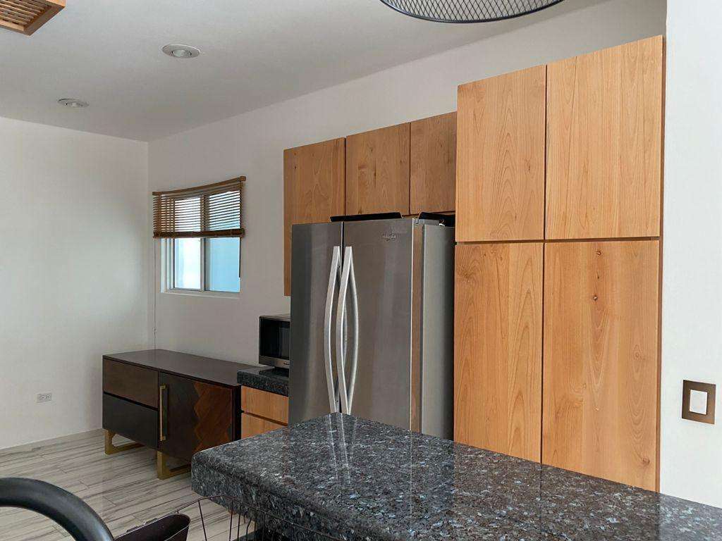 Los Cabos Villas De Oro Phase 1 Villa de Oro fantastic. Number 304 is very unique as it is one of a few town homes (most are upper or lower)that has a massive dramatic two story window that lights up the home. Downstairs has the impressive living and dining room. The kitchen has a new granite counter, a breakfast area and a bar for guests to enjoy the activity in the kitchen. Outside living with a big space to dine and sit around the large stone fireplace. Upstairs there are two bedroom suites, one of which has an outside terrace to enjoy the ocean for sale