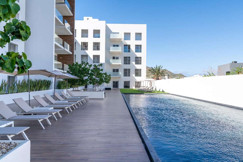 Los Cabos Marea Los Cabos Pelicano 402 is a turnkey 2-bedroom, 2-bathroom residence, fully furnished and move-in ready. Its open-concept layout seamlessly connects the living, dining, and kitchen areas to a spacious continuous terrace, also accessible from both bedrooms, creating effortless indoor-outdoor living. Designed to maximize privacy, natural light, and functionality, this home offers a peaceful and inviting atmosphere. Ideal as a full-time residence, vacation home, or investment property, it combines quality craftsmanship, contemporary finishes, and the added confidence of buying directly from the developer. – SN CALLE DEL PESCADOR, Cabo San Lucas, BS